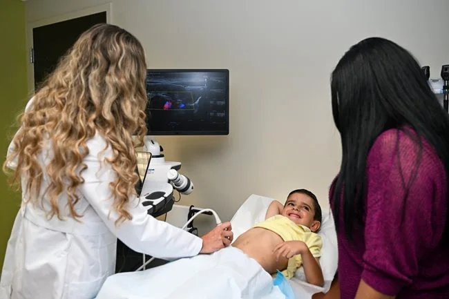 A boy being scanned by a doctor
