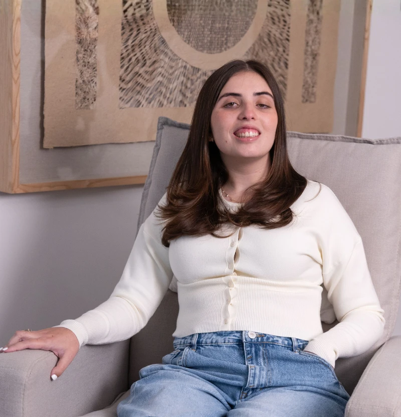 Katy squeezing her arm muscle showing strength.