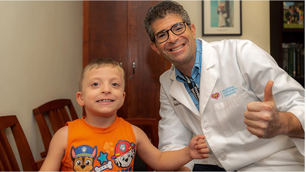 Dr. Perlyn gives the thumbs up next to a patient.
