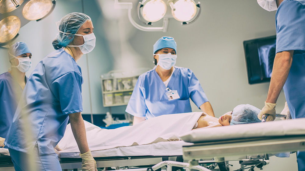 critical care doctors wheeling a patient to ER.