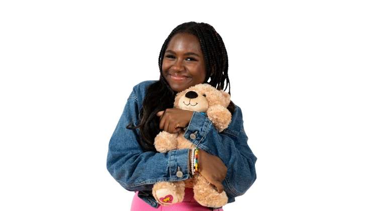 teenage girl hugging a teddy bear.