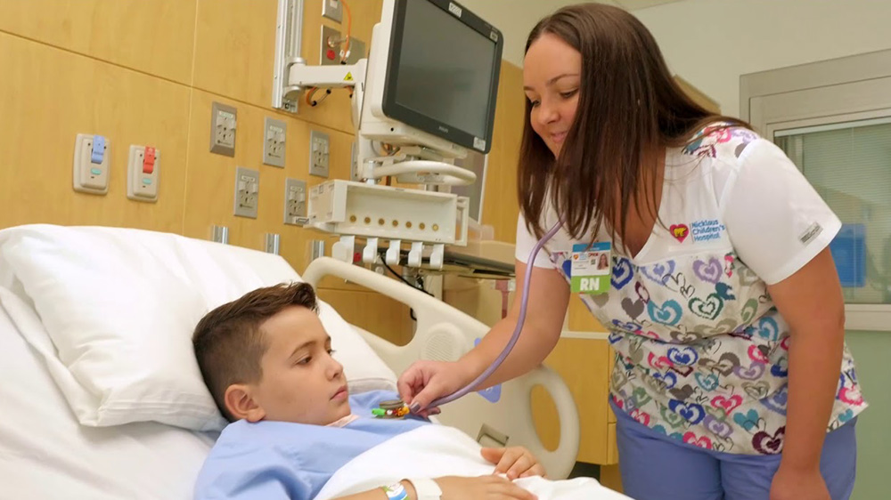 nurse practitioner attending a hospitalized boy.