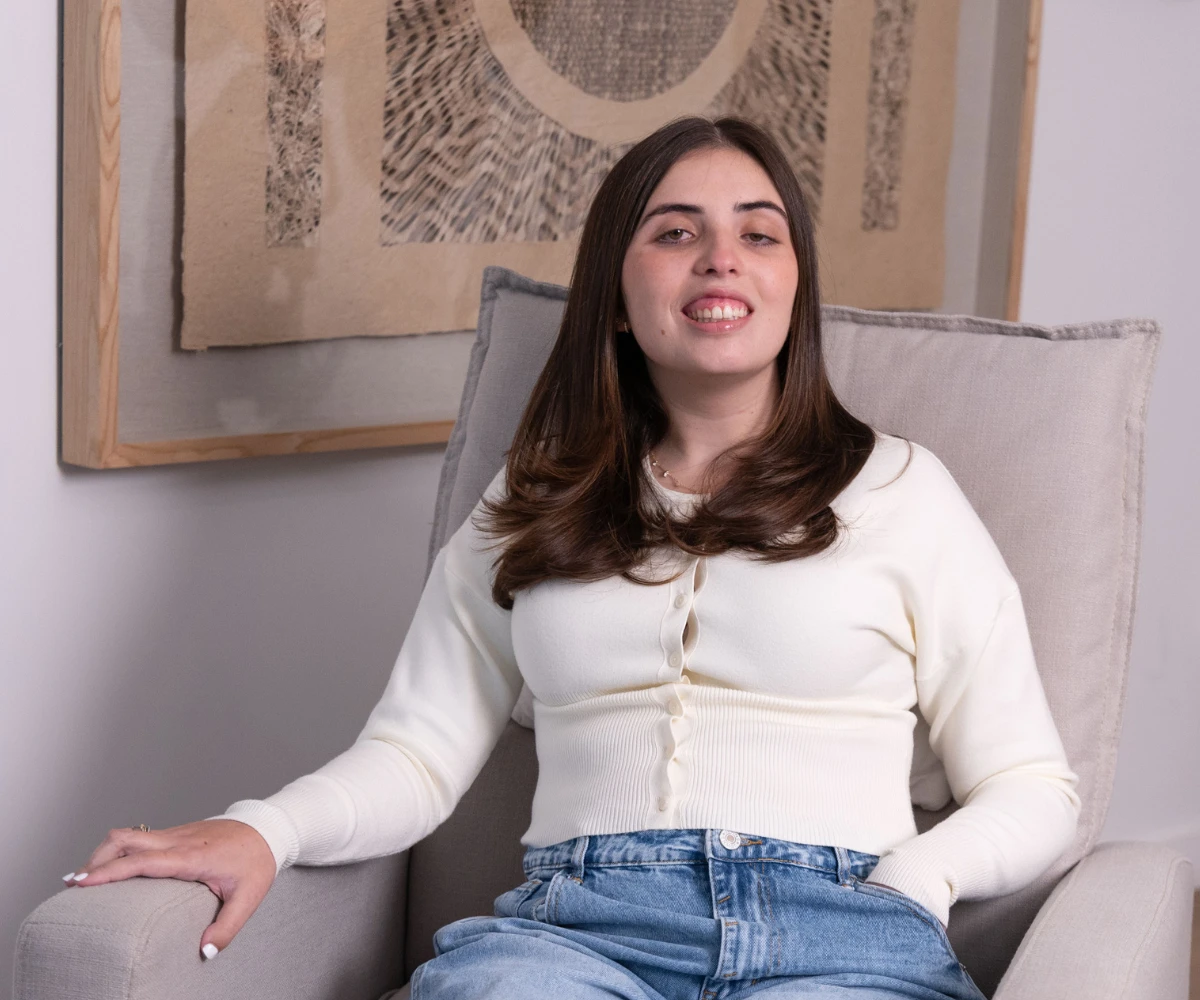 Katy squeezing her arm muscle showing strength.