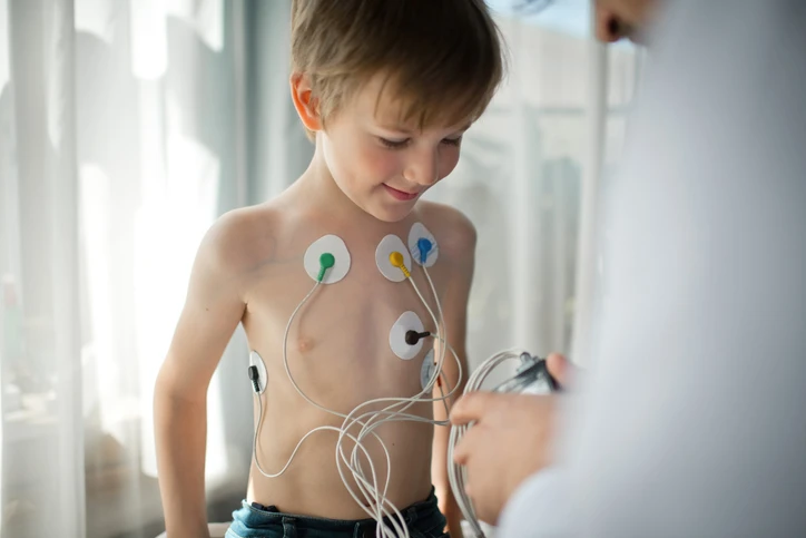 boy with electrodes taped to his chest.