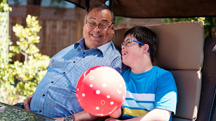 special needs boy chatting with grandparent.